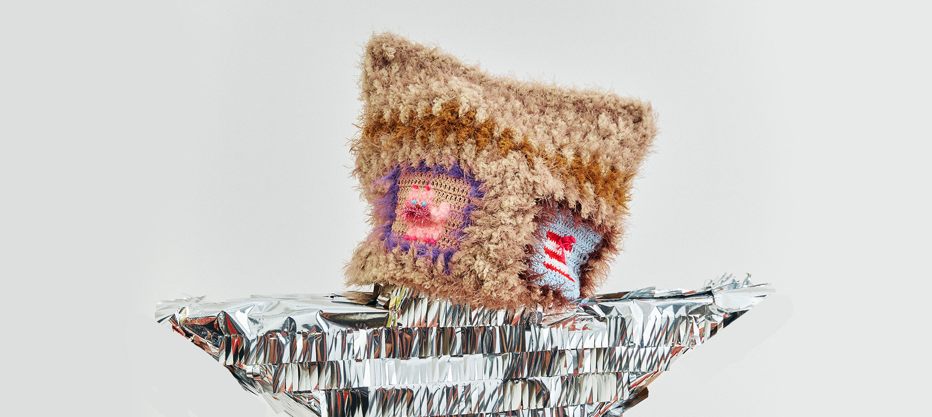 {"default":"FEEKY best sellers gallery featuring a whimsical handmade crochet hat on a silver foil boat, representing our most loved wearable fairytales"}
