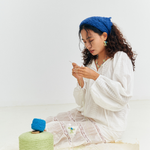 {"default":"artisan making crochet piece by hand in a calm setting"}
