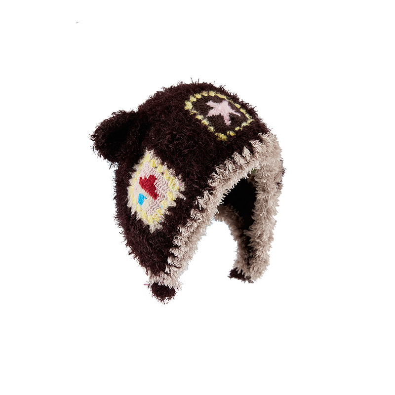 Little Lamb Patchwork Hat featuring fuzzy brown hand-crocheted texture, cream trim, lamb ears, and colorful crochet patches on a white background.