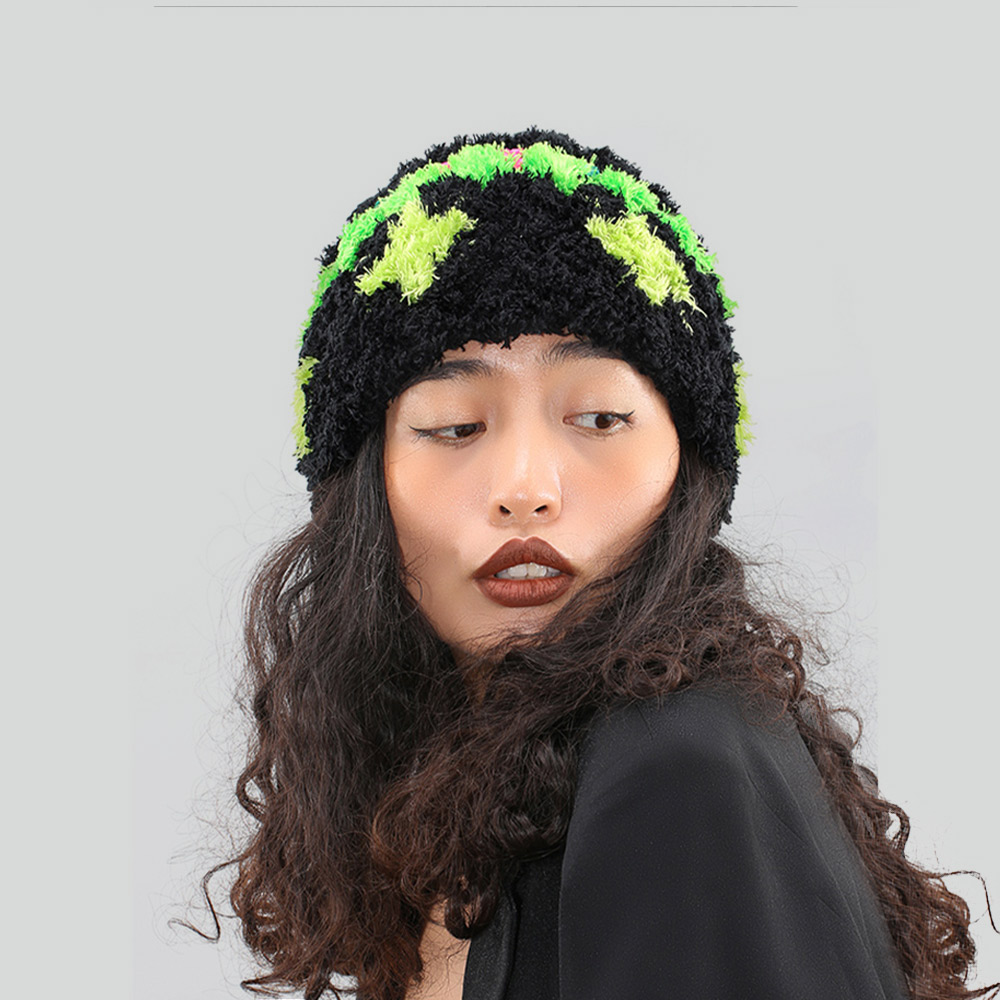 Front-angled view of the black woolen crochet beanie on a model, highlighting the cozy textured fit and bold dopamine color contrast.