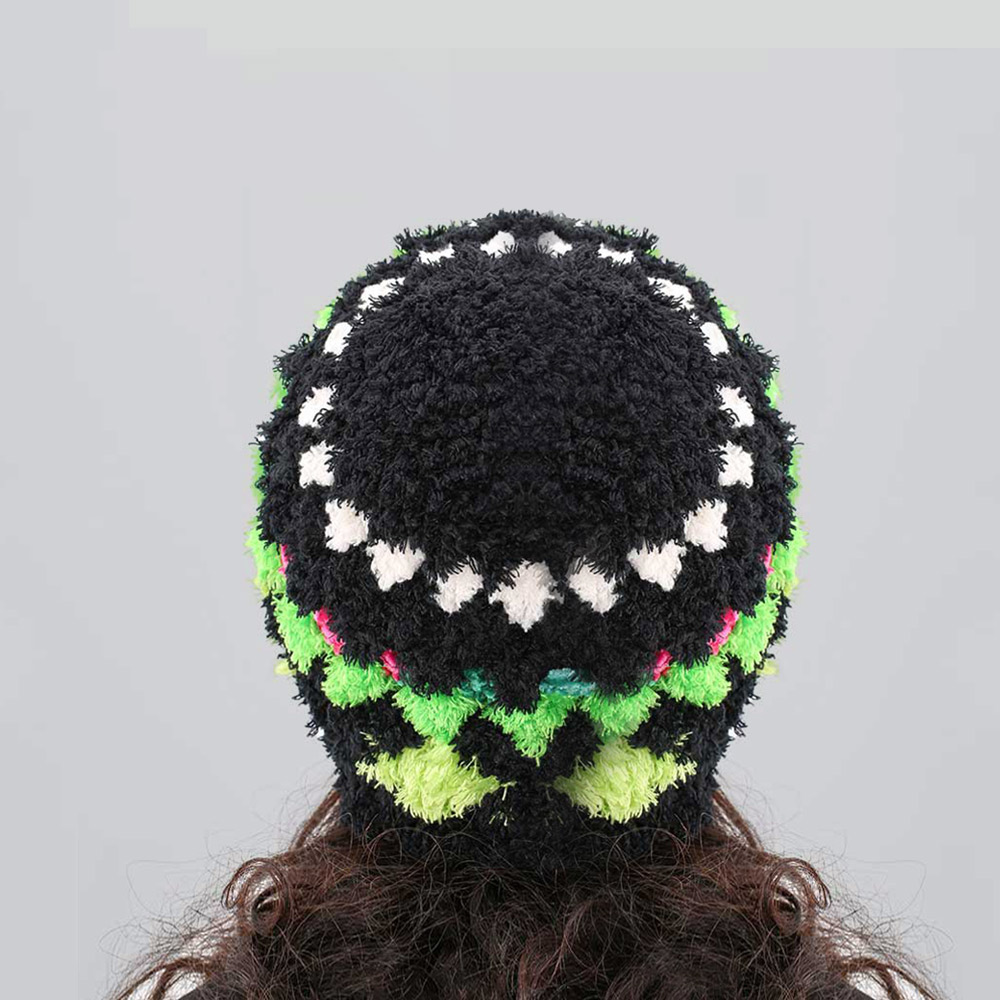 Back view of the black woolen crochet hat from behind, illustrating the complete circular pattern layout of neon green and pink stitch details.