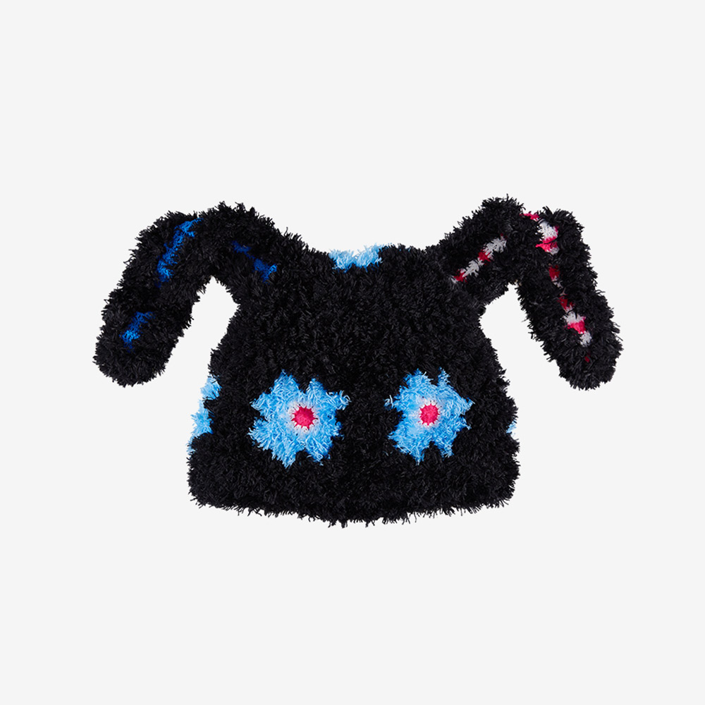 Isolated product image of the handmade black Bunny Ear Crochet Hat on a white background, highlighting the blue flower elements and long drooping ears.
