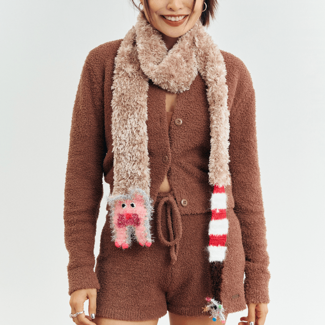 FeekyStore fluffy brown cat star scarf worn by a smiling model in a brown knit cardigan set against a clean white studio background, front view.