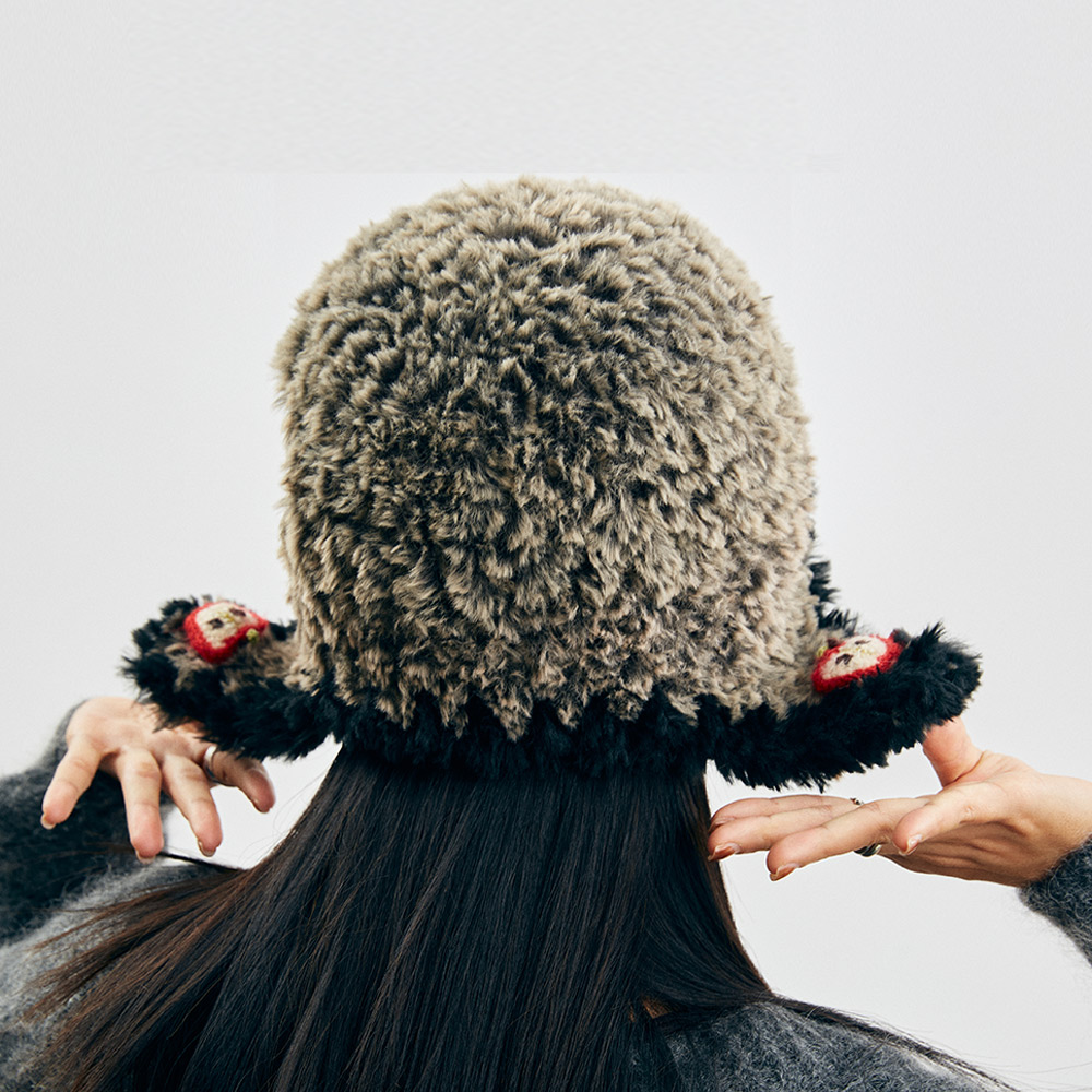 Back view of the fluffy Cloud-Pooch Crochet Aviator Hat from behind the model, showing the full coverage of the cozy textured earflaps.