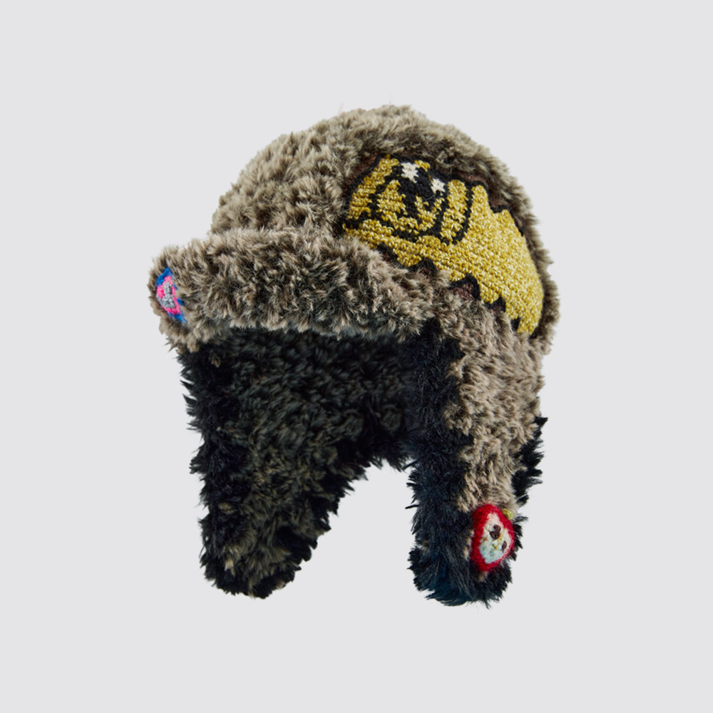 Isolated product image of the handmade Cloud-Pooch Crochet Aviator Hat against a clean background, featuring fluffy earflaps and a yellow dog graphic design.