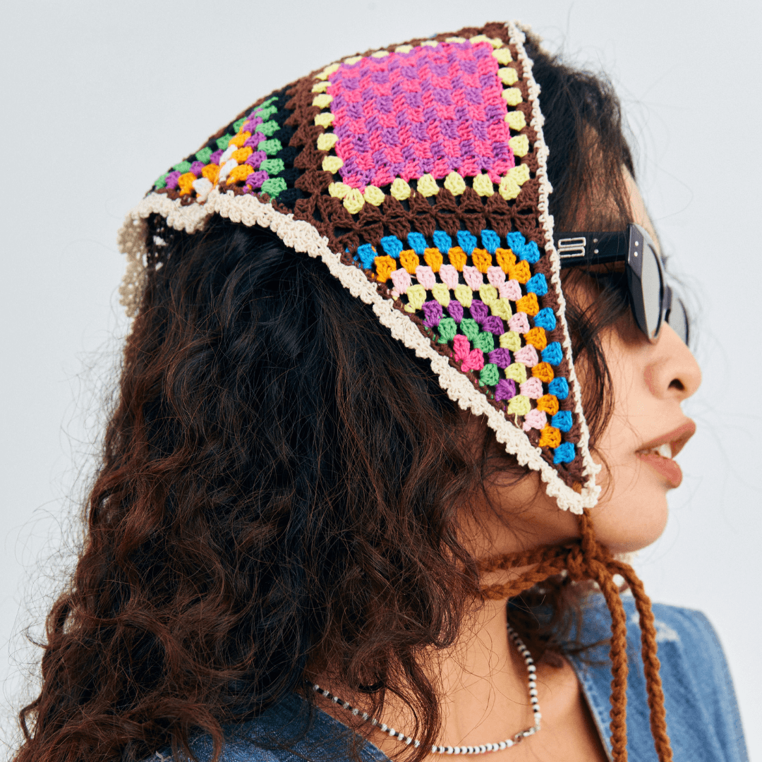 FeekyStore colorful crochet triangle headscarf featuring side ties and intricate multi-colored patchwork in a studio setting.