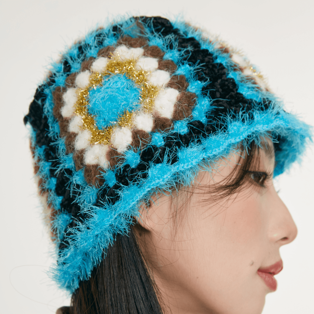FeekyStore crochet Fisherman Hat showing a close-up side profile of the vibrant blue and black geometric granny square pattern in a clean studio setting.