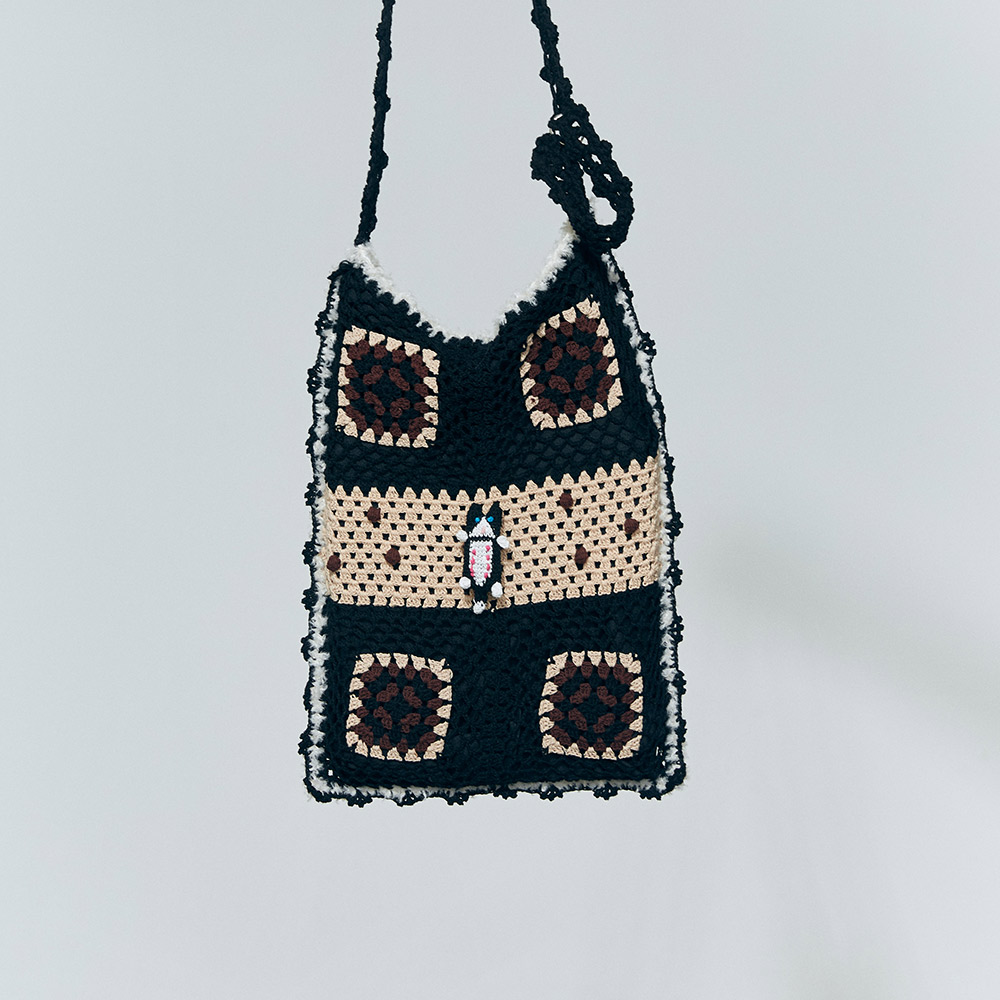 Isolated product display of the Lying Flat Cat Crochet Messenger Bag, highlighting the brown and black square grids with a contrast long strap.