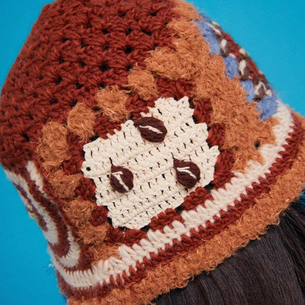 Close-up shot of the Refreshing Coffee Crochet Hat, showcasing the 3D textured crochet coffee beans on a cream block with popcorn stitch borders.