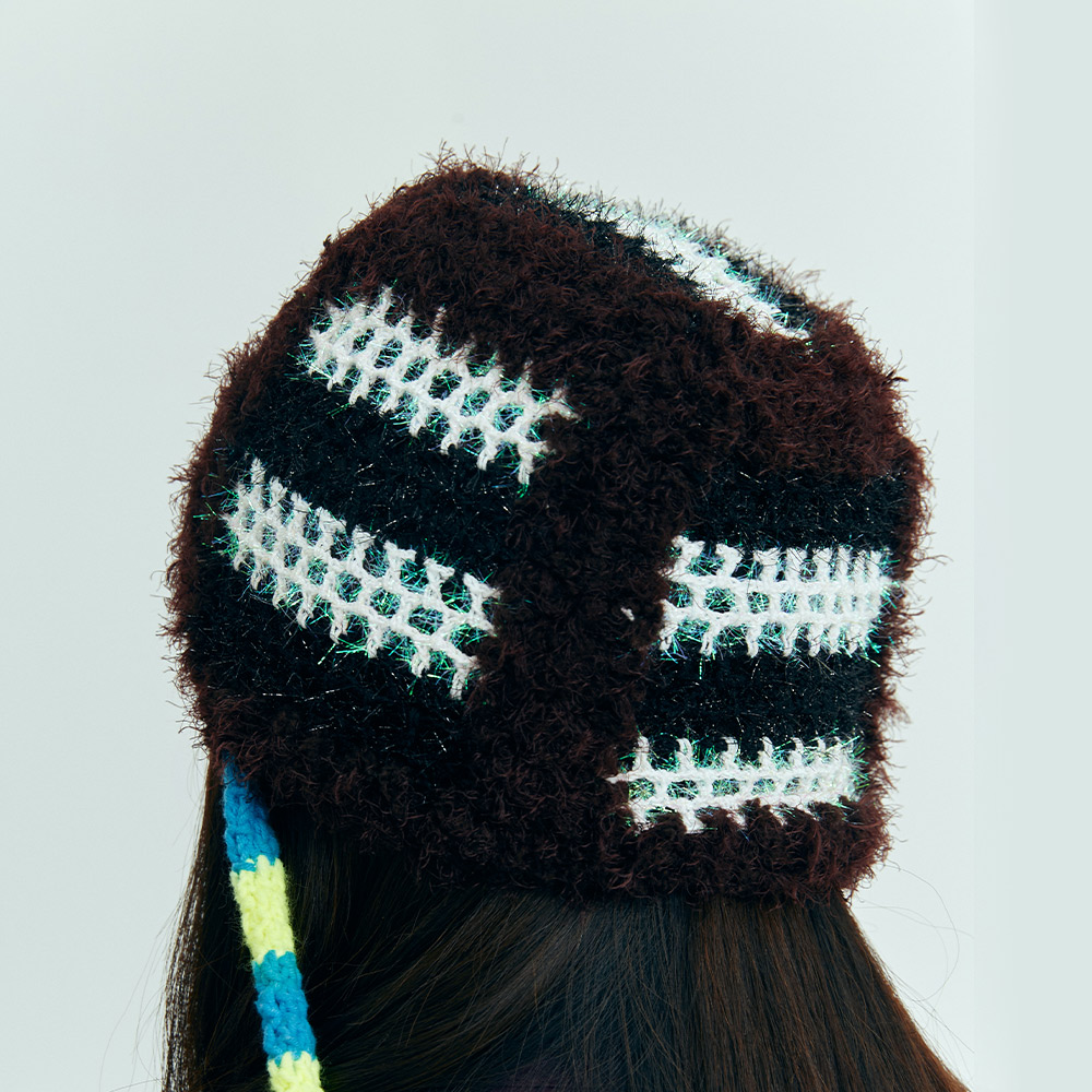 Back view of the fluffy Snake Crochet beanie from behind the model, showing the striped open-work stitch pattern and fuzzy yarn texture.