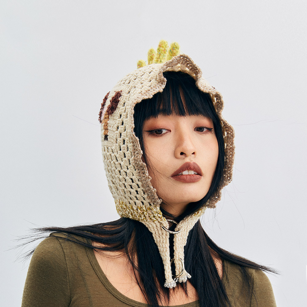 Front view of a model wearing the Unicorn Pony Crochet balaclava hat, showing the wavy scalloped border framing the face.