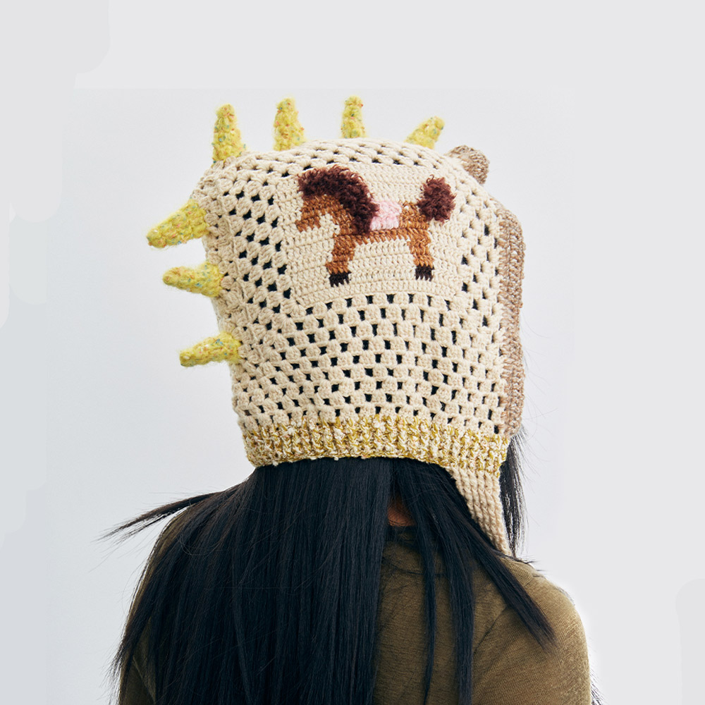 Back view of the Unicorn Pony Crochet Hat on a model, showcasing the yellow unicorn spikes along the center and the detailed pony design.