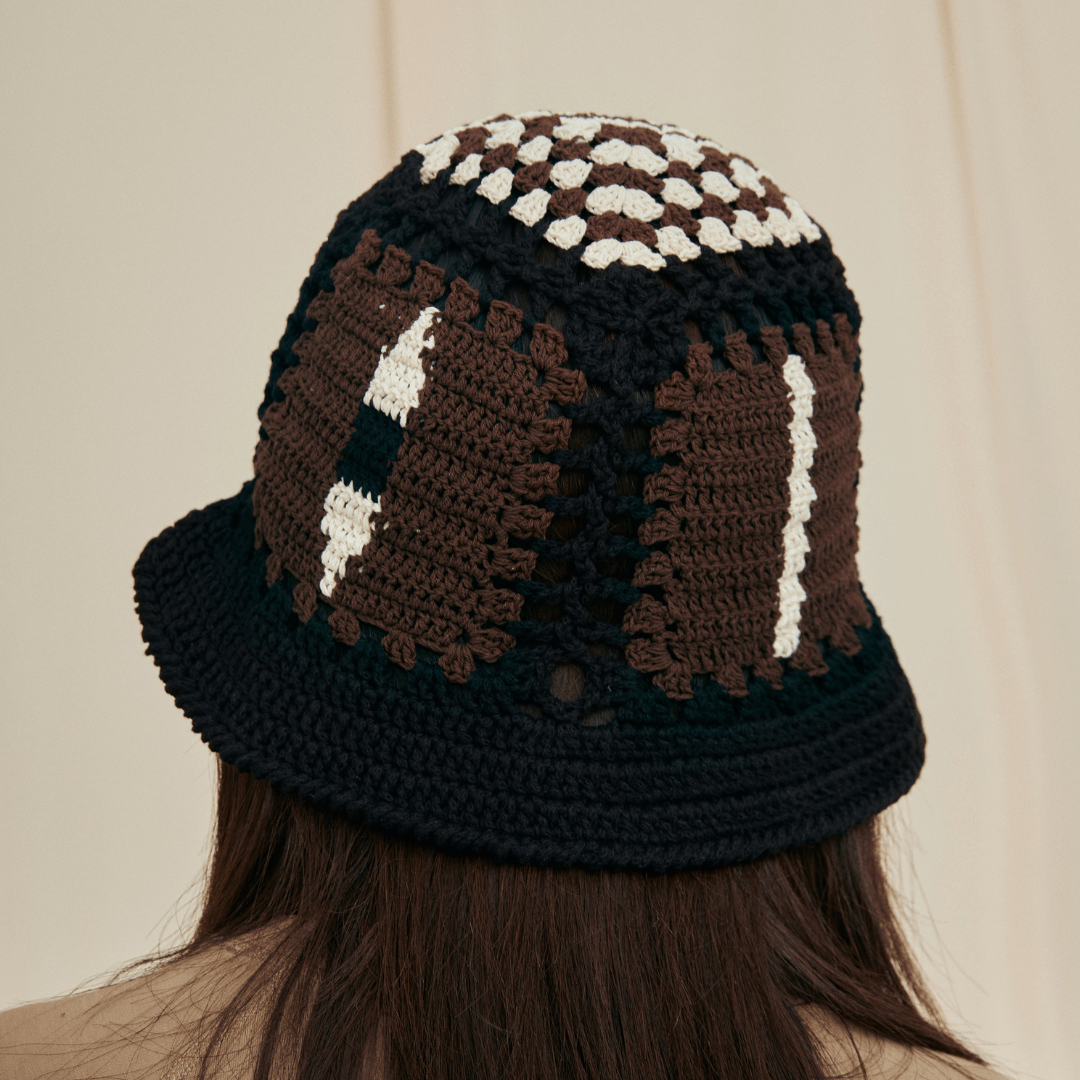 FeekyStore black and brown crochet vase hollow hat viewed from the back, showcasing the geometric crown patchwork in a clean studio setting.