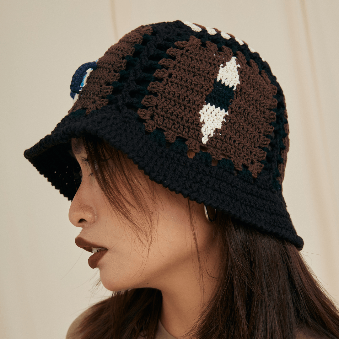 FeekyStore black crochet vase hollow hat shown from a side-front angle, highlighting the brim and intricate artisanal detailing.