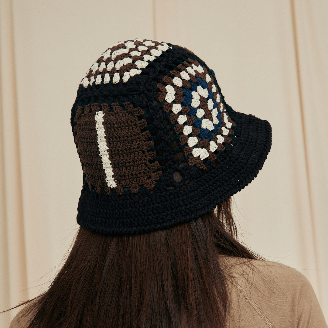 FeekyStore black crochet vase hollow hat showcasing side-back geometric and striped crochet patterns in a studio portrait.