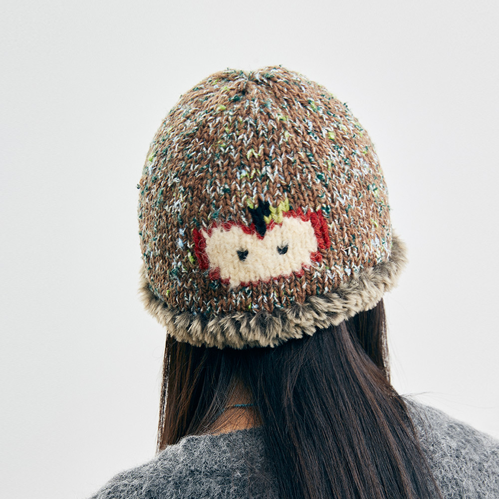 Back view of the Wool Apple Crochet Hat from behind the model, illustrating the snug fit and cozy texture of the beanie.