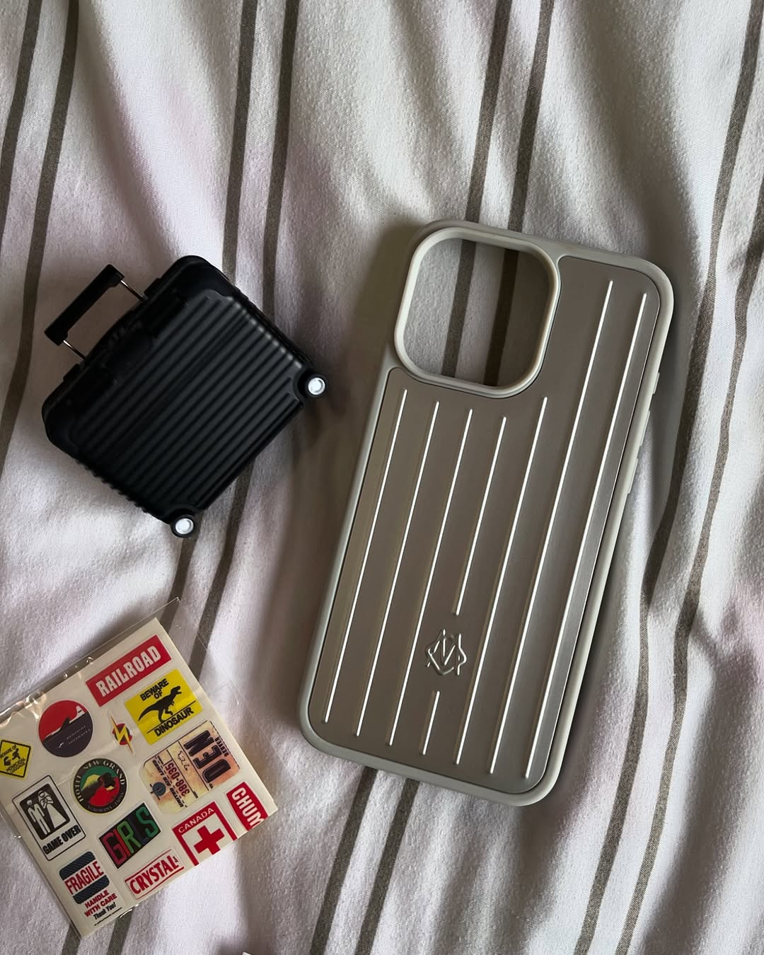 Rimowa-inspired metallic iPhone case with signature grooves.