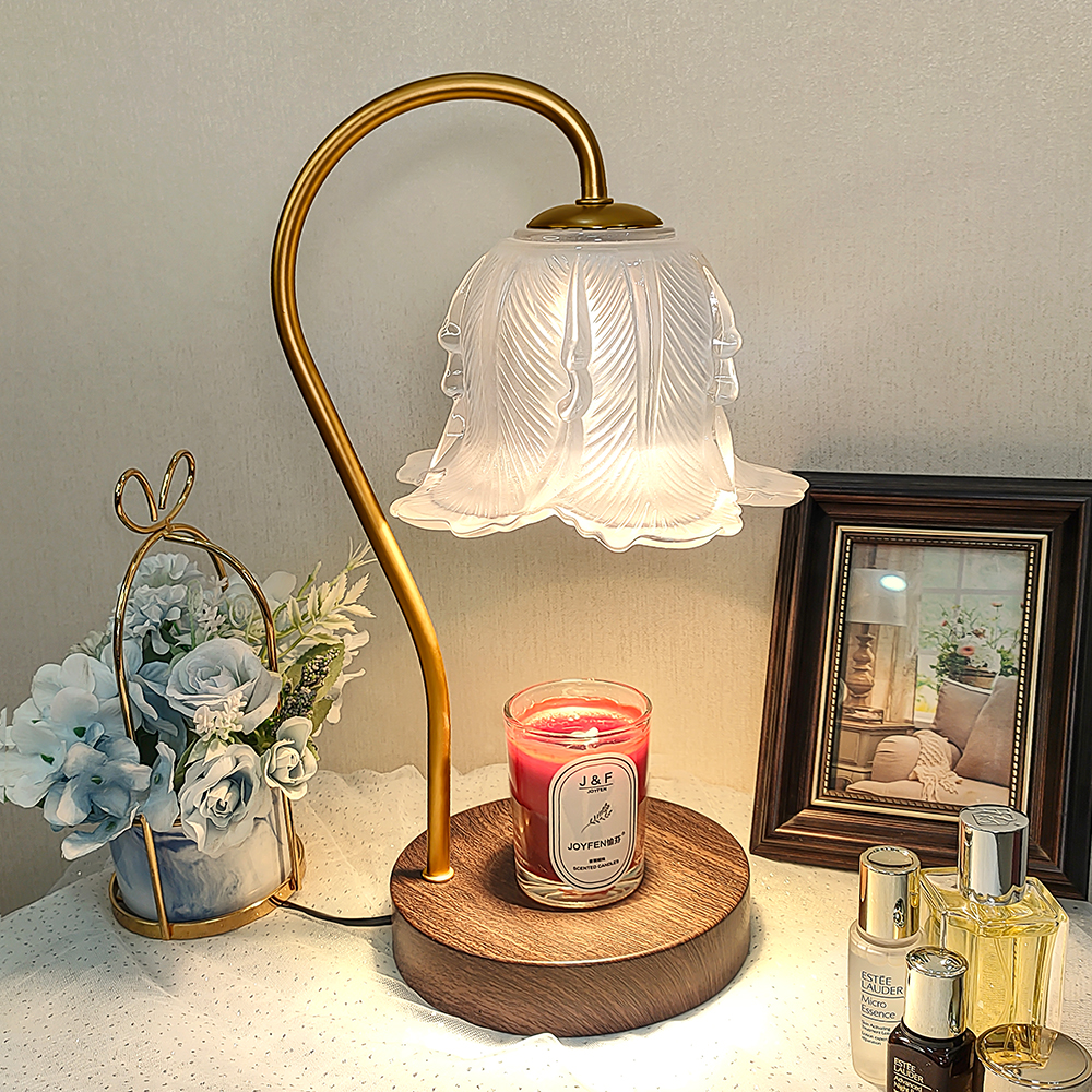 An aromatherapy candle floral table lamp sitting on a table with small decorations. 