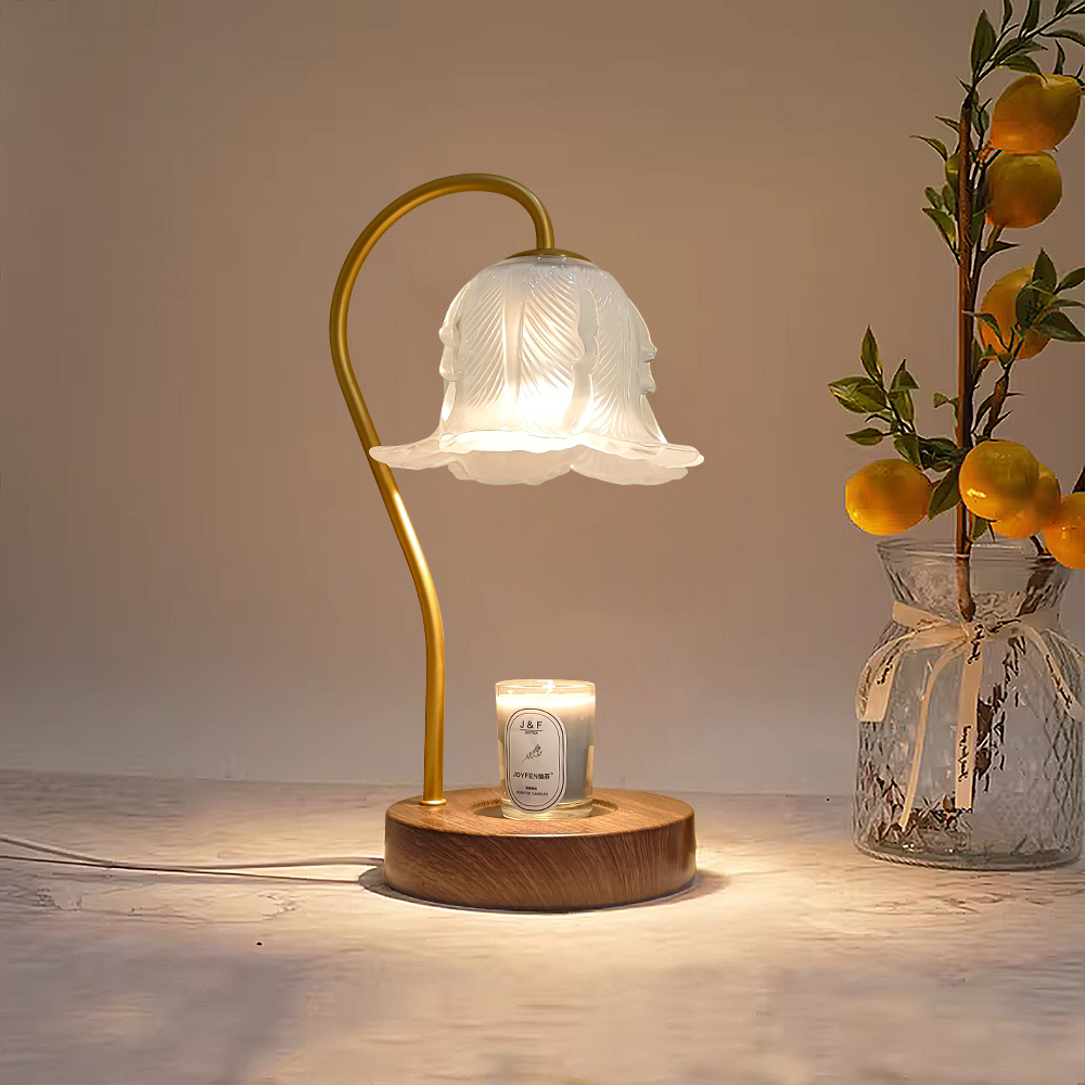 An aromatherapy candle floral table lamp sitting next to a table decoration