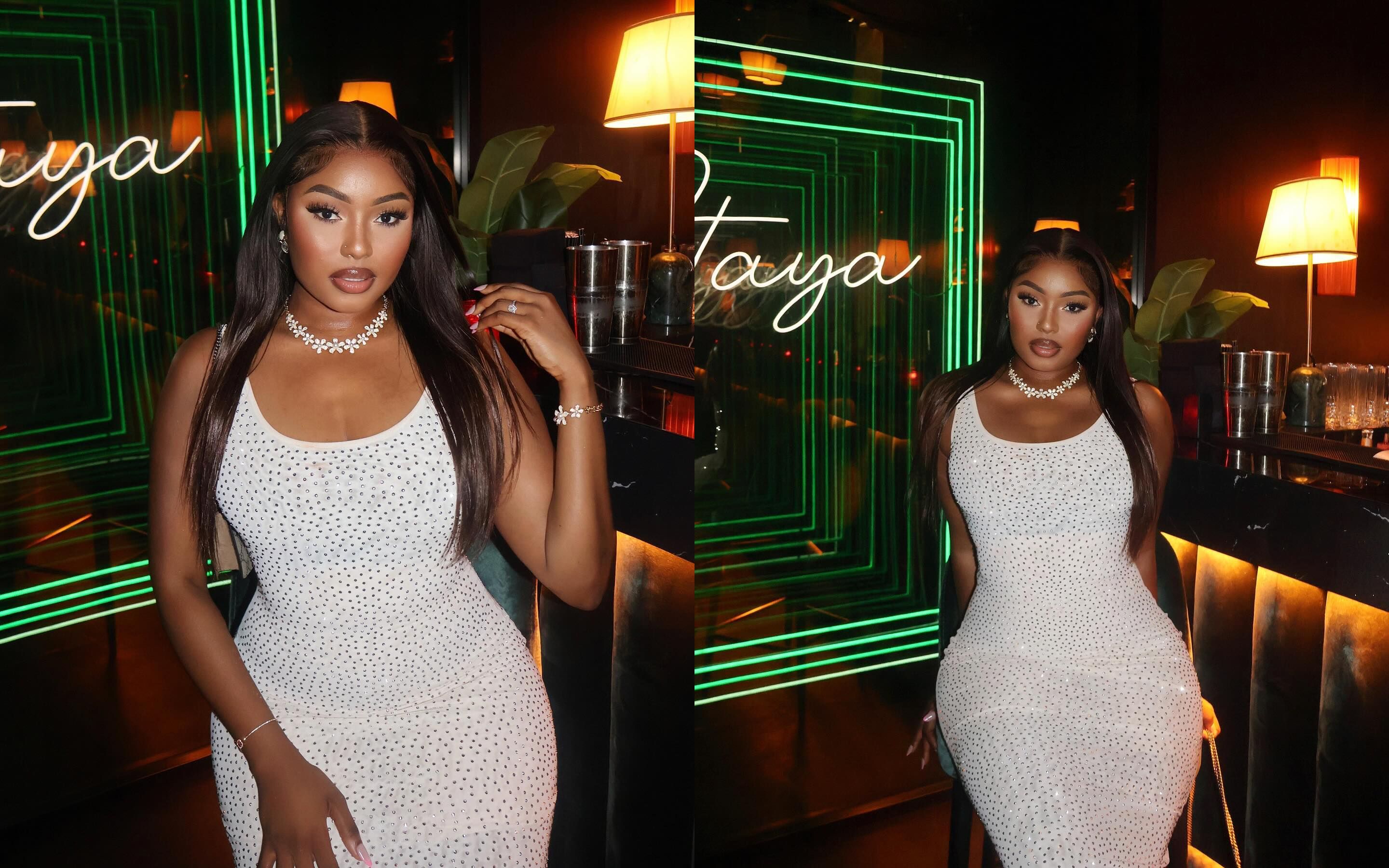 Empowered plus-size woman, with confidence and poise, showcasing the perfect fit and luxurious detail of a sparkling Bella Barnett white evening dress in a sophisticated lounge setting for 2026 formal wear inspiration.