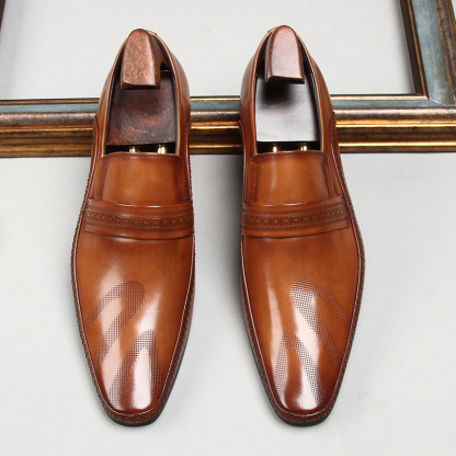 brown slip-on loafers with engraved strap detail
