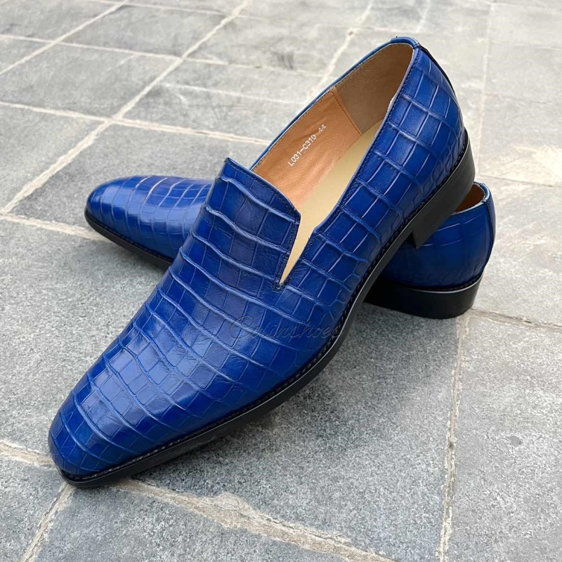 Right-side perspective of handcrafted blue embossed leather dress shoes.
