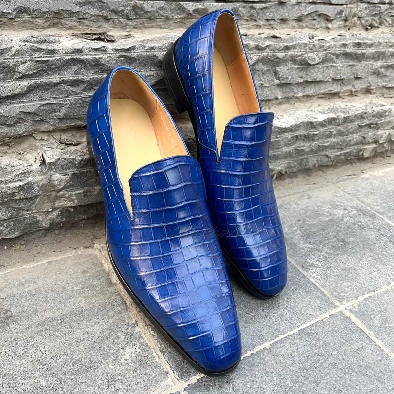 Blue crocodile embossed leather loafers, elegant slip-on design for men.