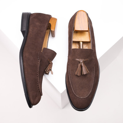 Men wearing suede tassel loafers with tailored trousers