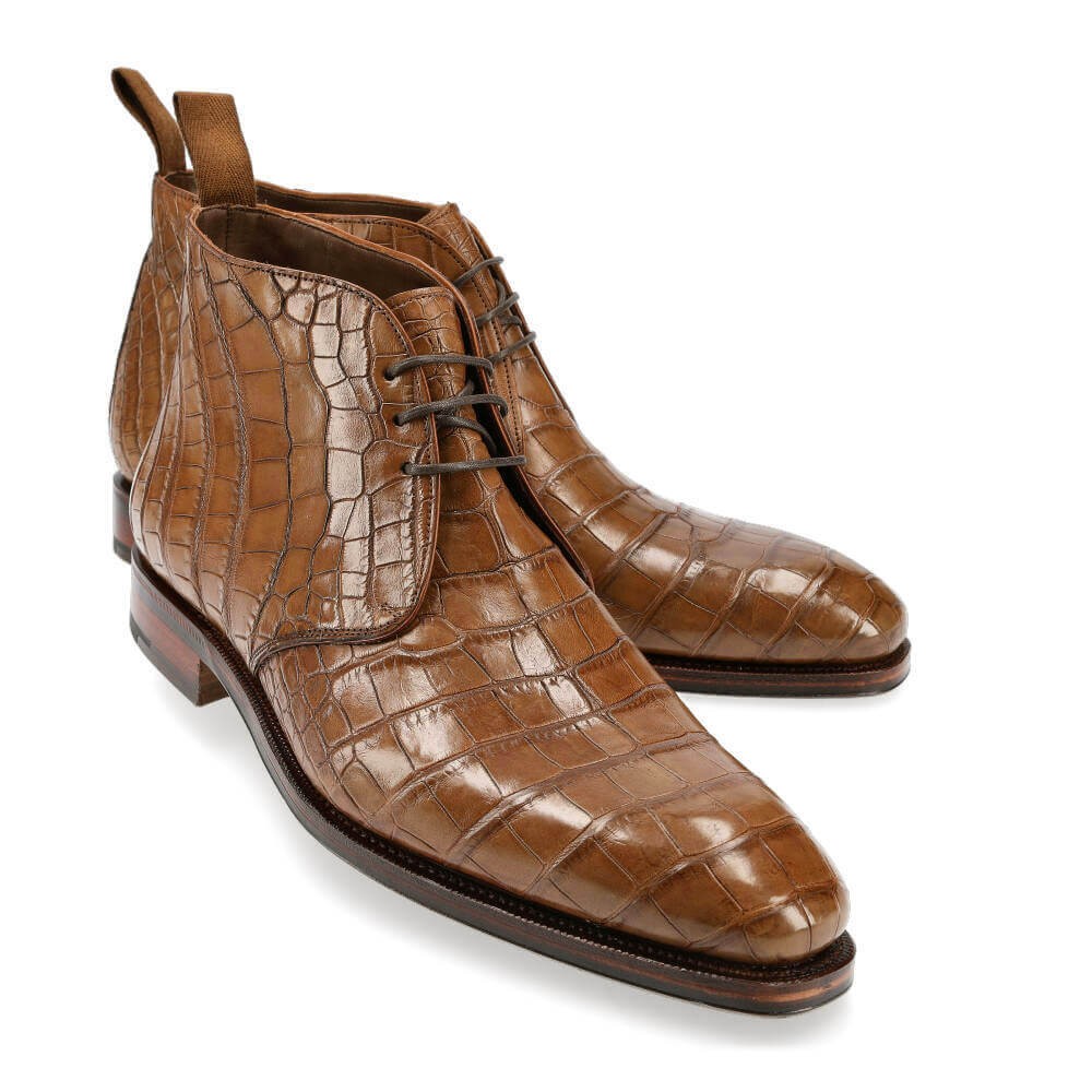Left angled view of high-shine embossed gator leather ankle boots-Colinshoes