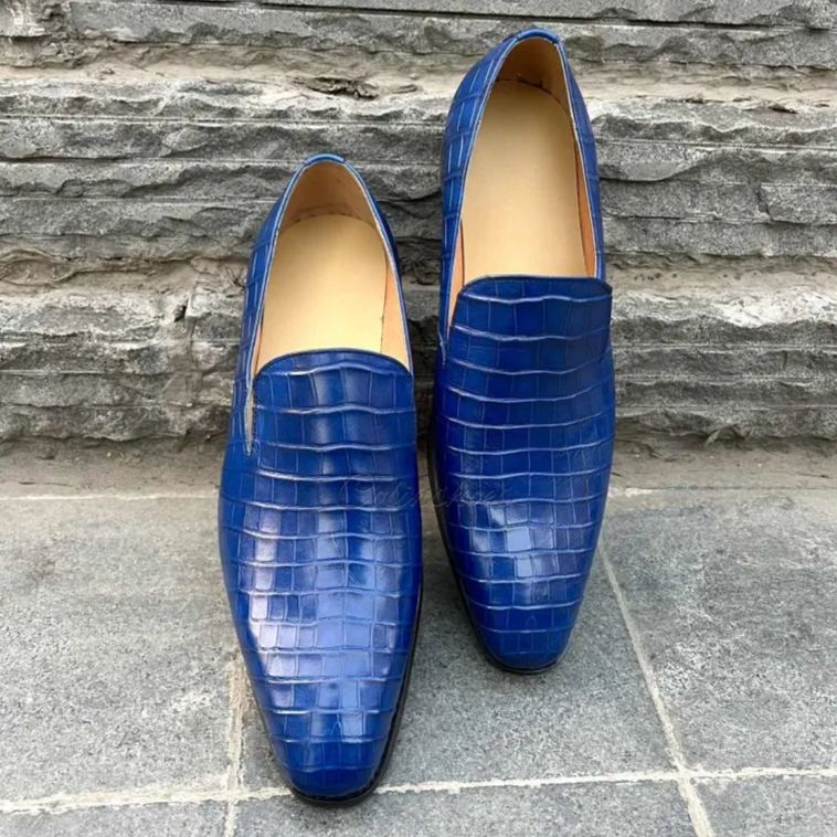 Close-up showing detailed crocodile texture and sleek blue finish.