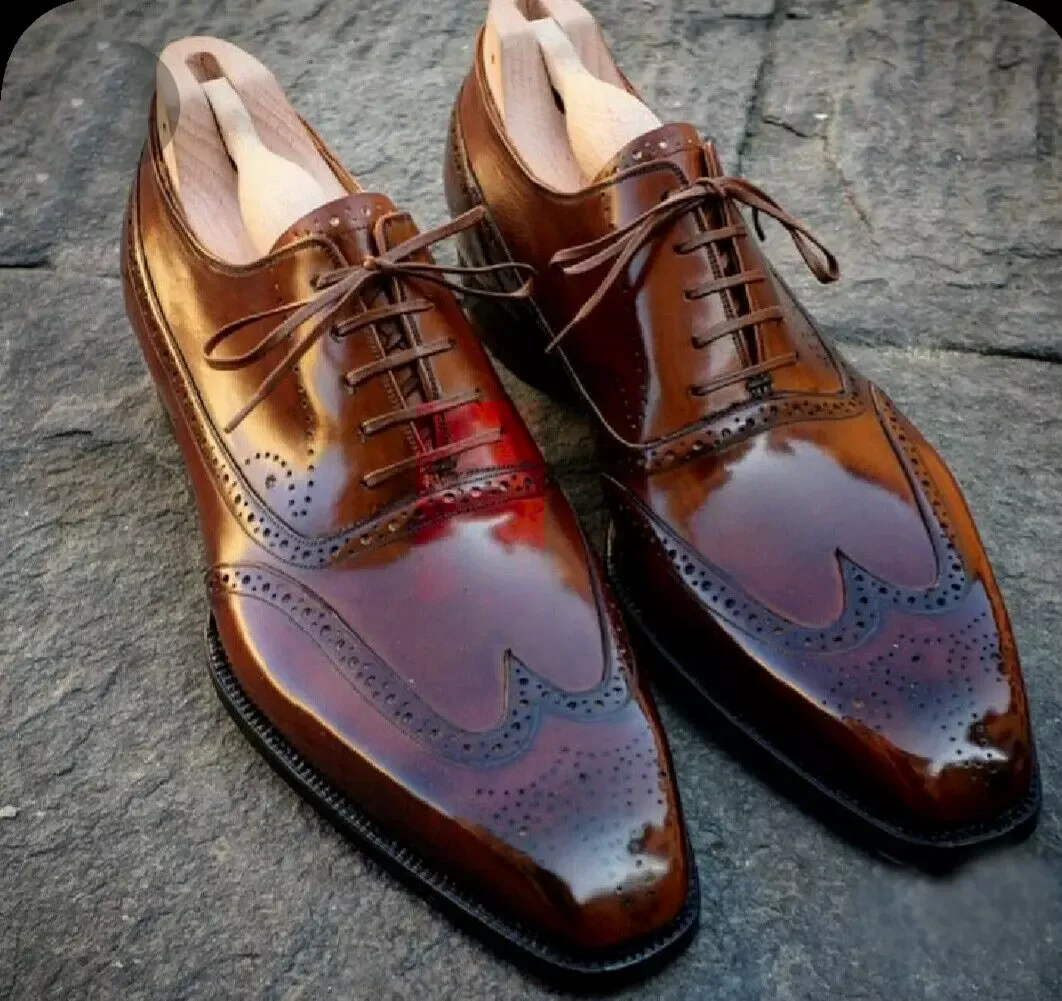 glossy brown Oxford brogues with wingtip detailing on stone floor-Colinshoes