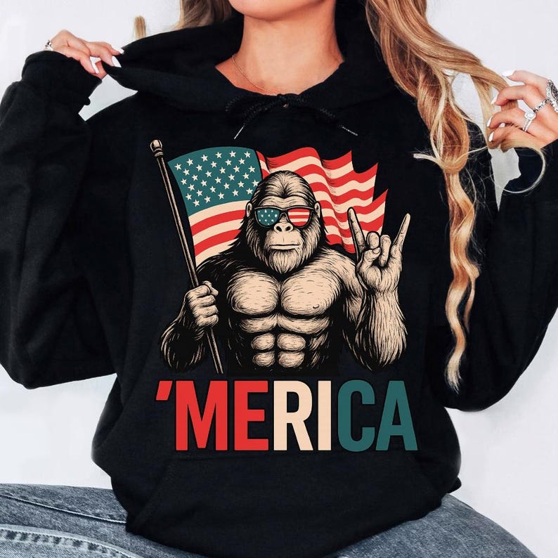 T - Shirt with a Fun Twist: Iconic Bigfoot Figure Holding Flag