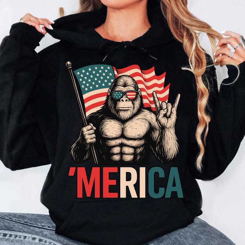 T - Shirt with a Fun Twist: Iconic Bigfoot Figure Holding Flag