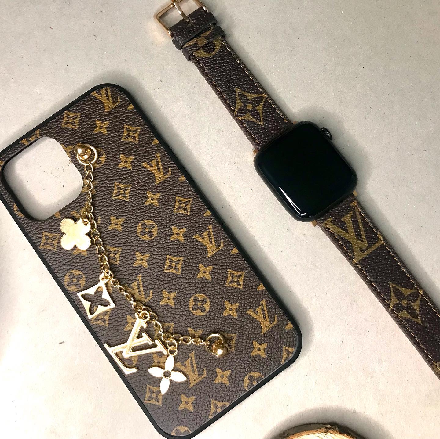A detailed close-up shot of the materials and texture of a premium iPhone case and Apple Watch band.