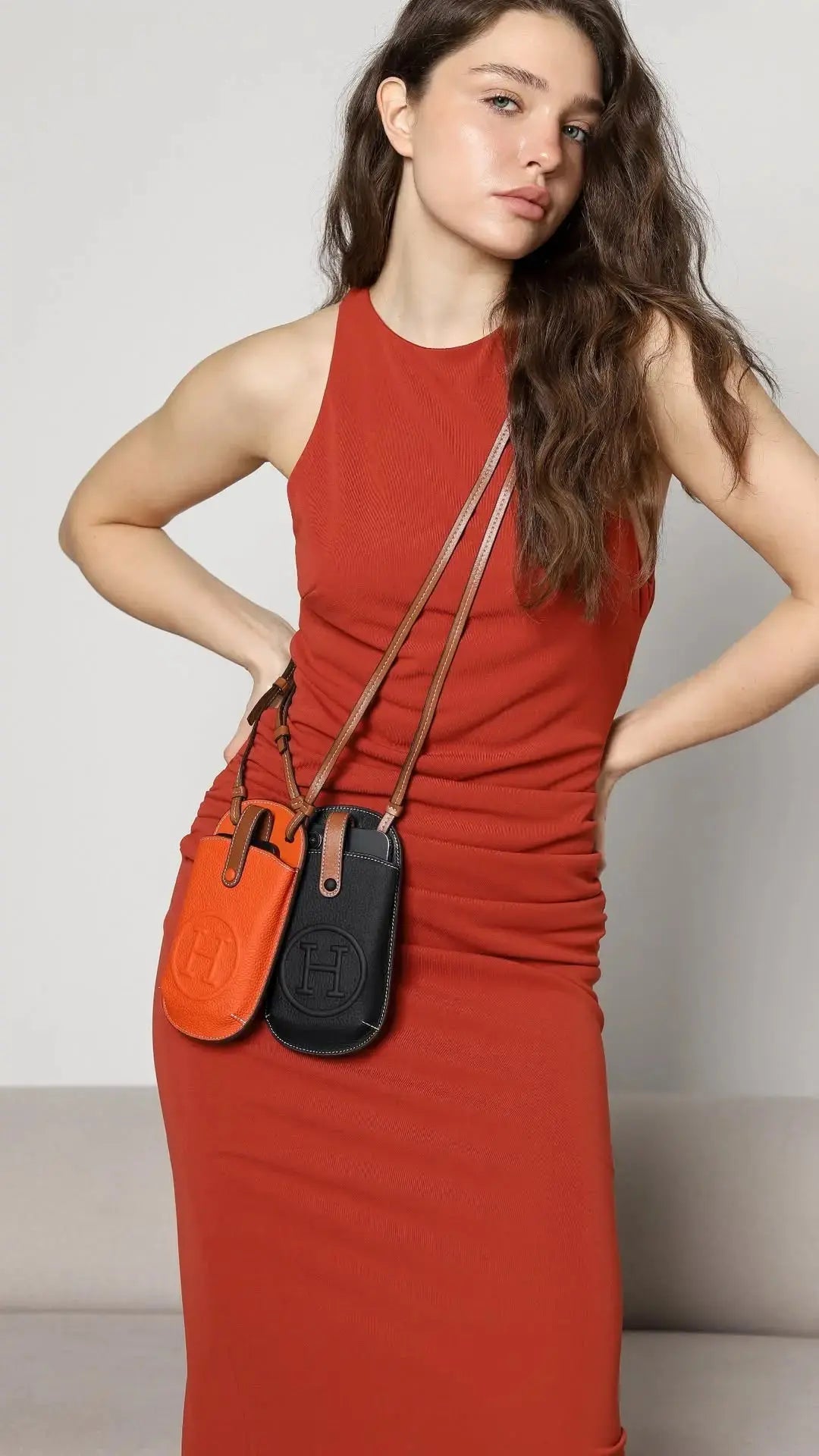 A stylish woman holding a luxury iPhone case and an Apple Watch, highlighting the tech as a fashion statement.