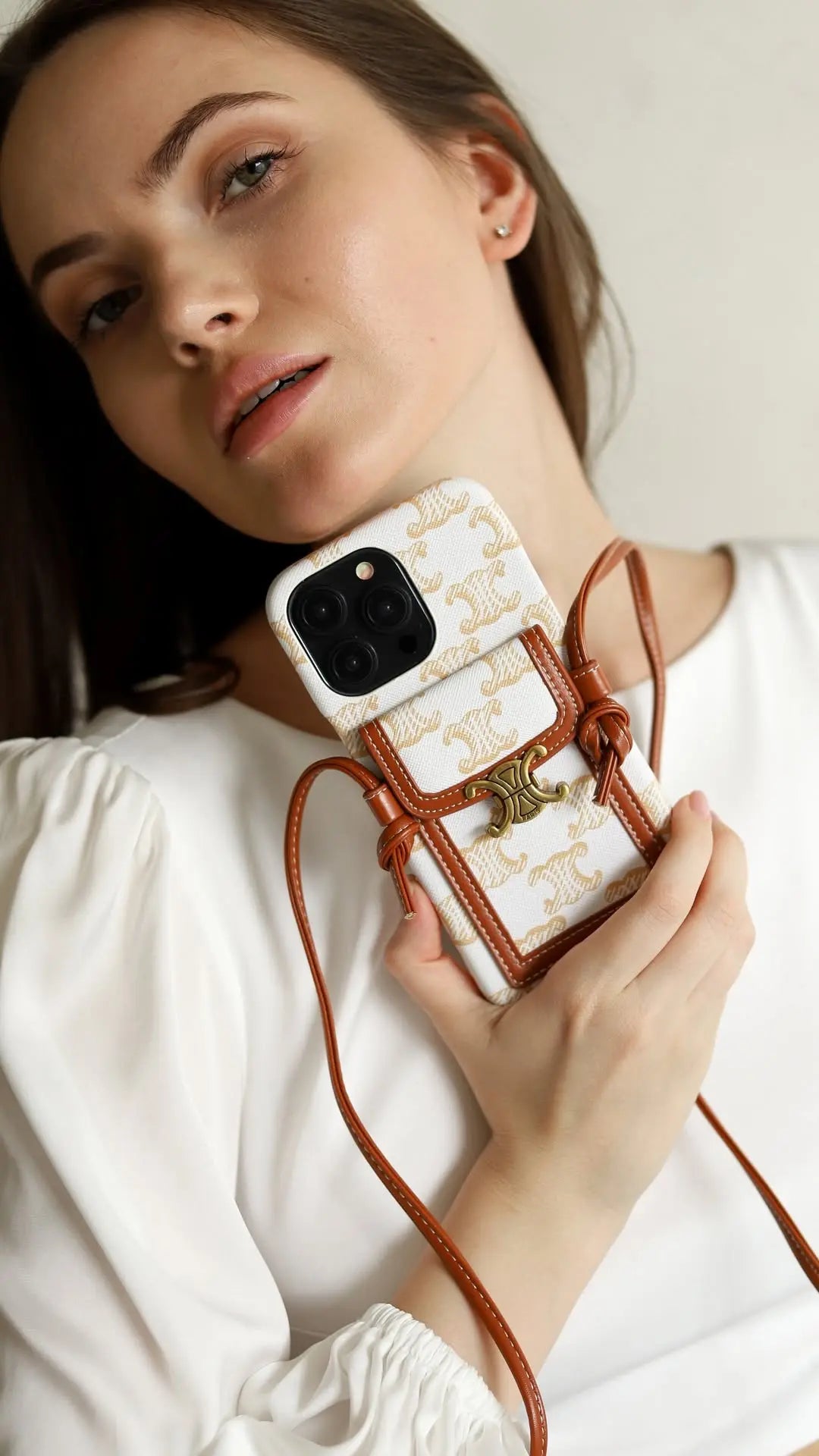 A Celine-inspired high-end iPhone cover with a sleek crossbody strap, showcasing functional minimalism.