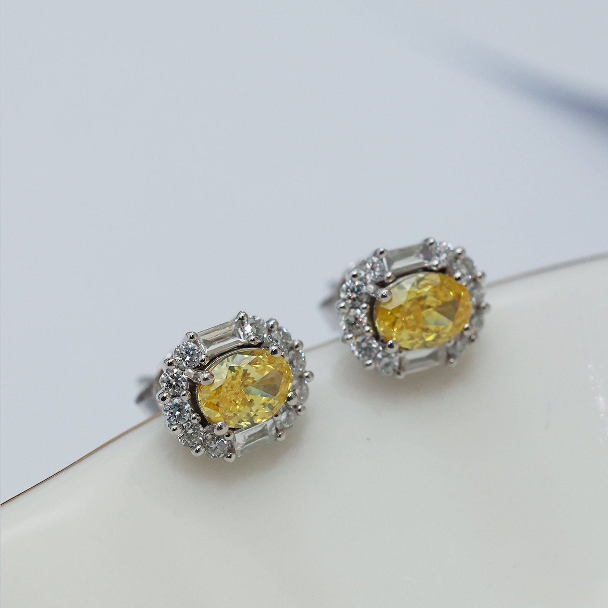 IGI Certificated 1.2 Carat Total Weight Halo Oval Cut Yellow Diamond Stud Earrings in 18k White Gold