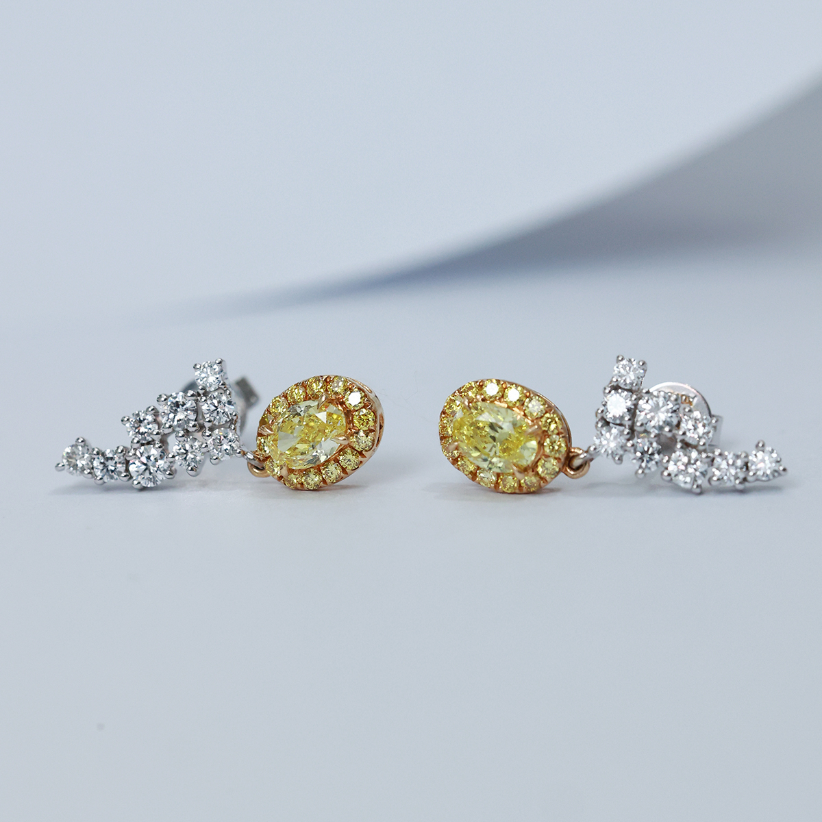 1.2 Carat Total Weight Halo Oval Cut Yellow Diamond and White Diamond Earrings in 18k White Gold