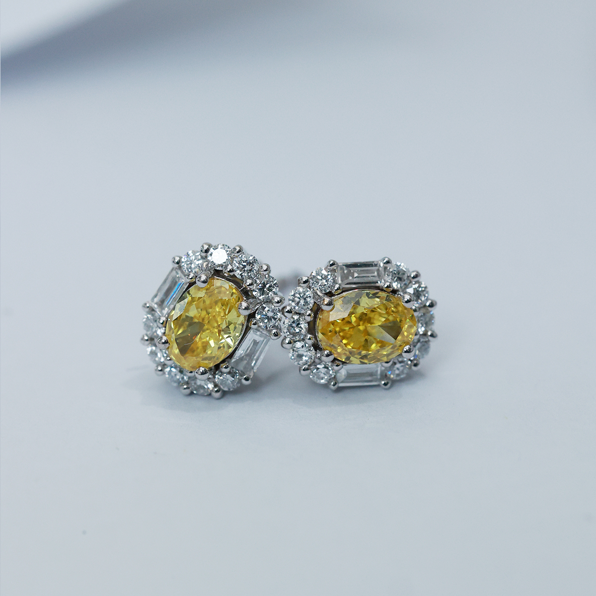 IGI Certificated 1.2 Carat Total Weight Halo Oval Cut Yellow Diamond Stud Earrings in 18k White Gold