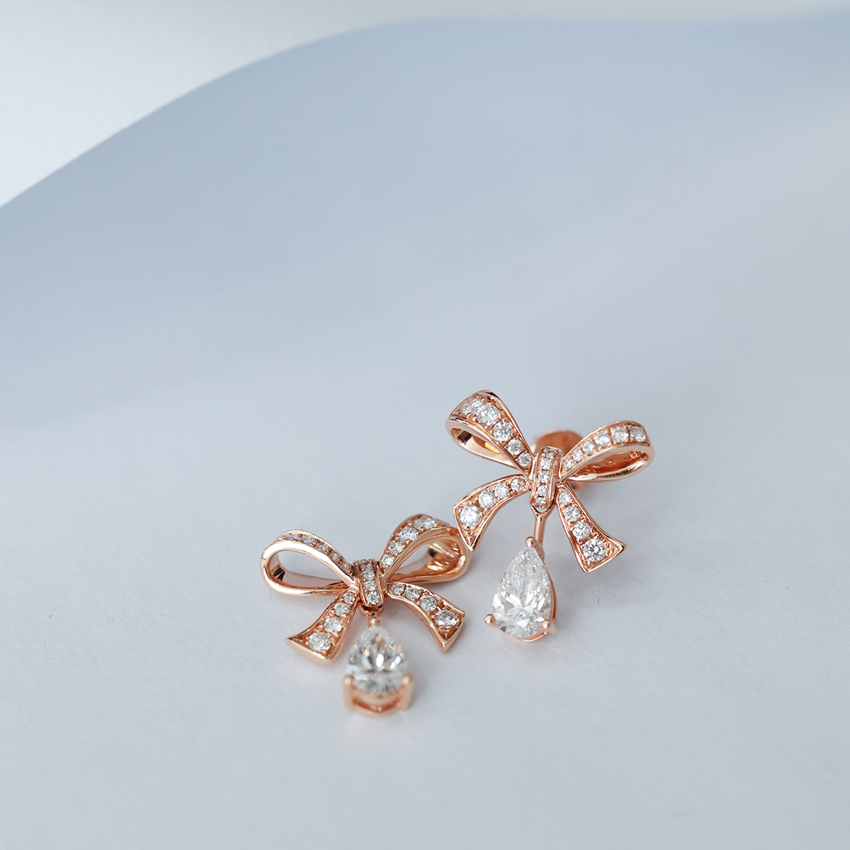 1.2 Carat Total Elegant Diamond Ribbon Bow with Pear Cut Drop Diamond Stud Earring in 18k Rose Gold 