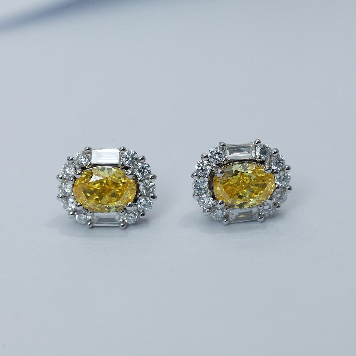 IGI Certificated 1.2 Carat Total Weight Halo Oval Cut Yellow Diamond Stud Earrings in 18k White Gold