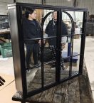 A mirror hanging cabinet is black