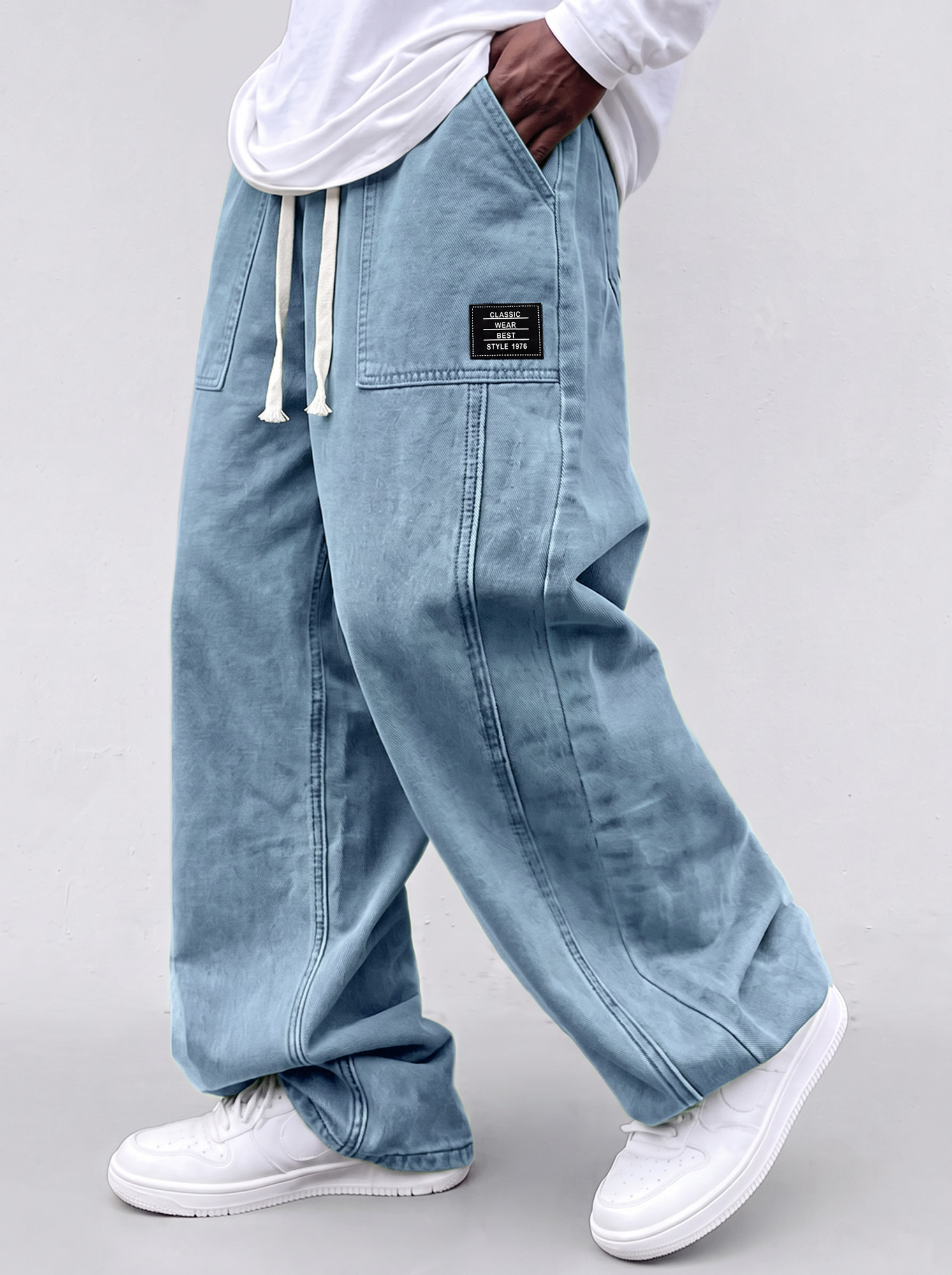 Men's casual straight-leg trousers with a deconstructed design and patch pockets.