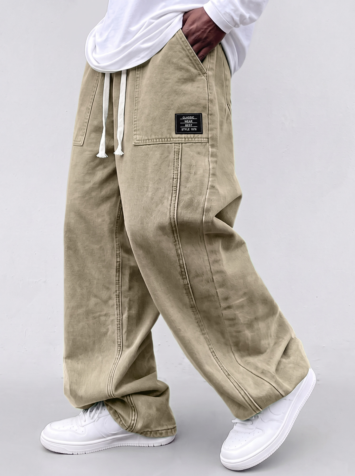 Men's casual straight-leg trousers with a deconstructed design and patch pockets.