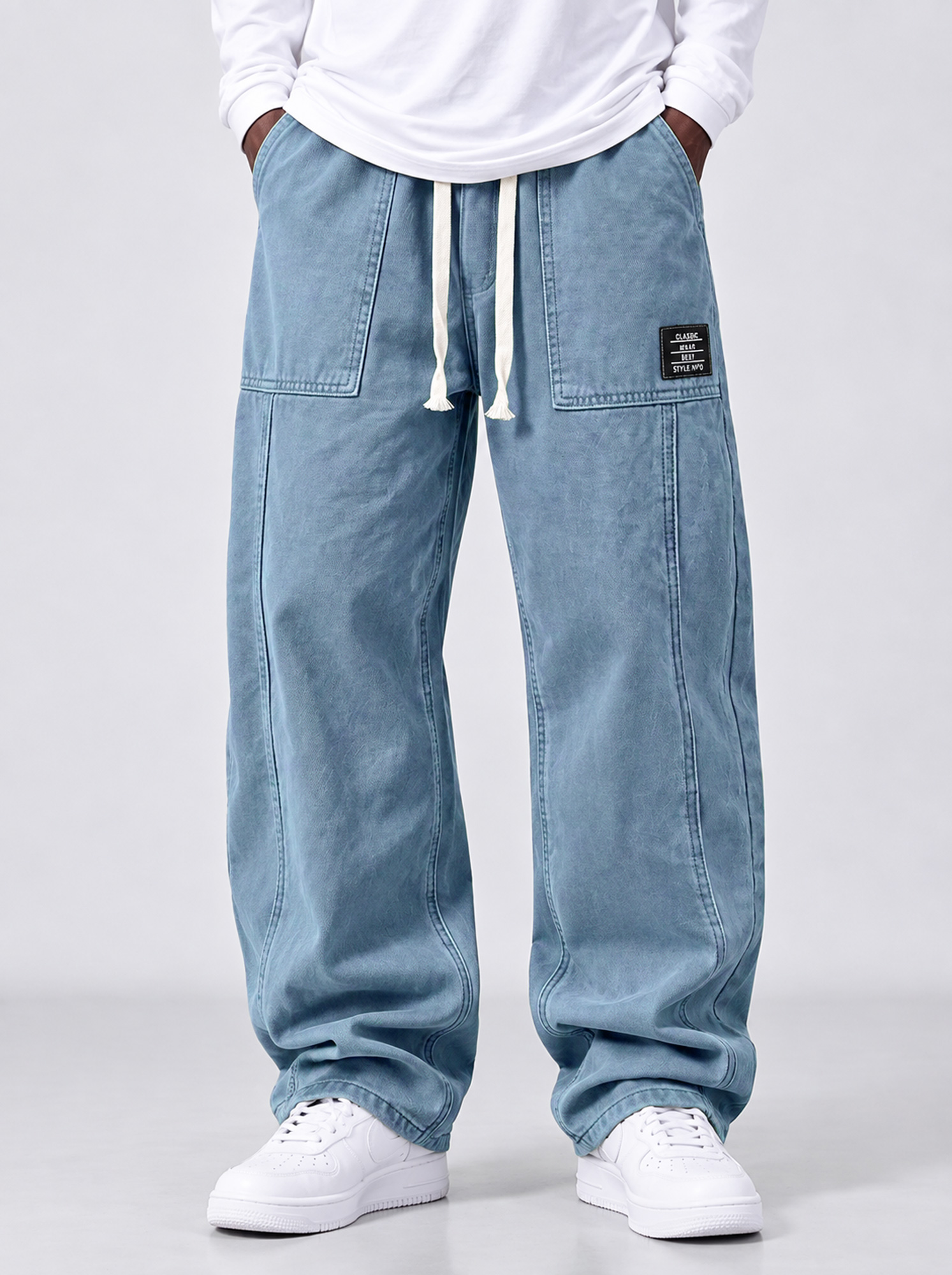Men's casual straight-leg trousers with a deconstructed design and patch pockets.
