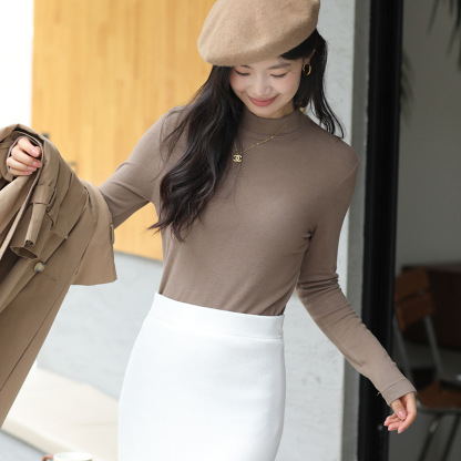 Long sleeved top with high collar on the outside and knitted sweater on the inside