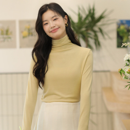 Long sleeved top with high collar on the outside and knitted sweater on the inside