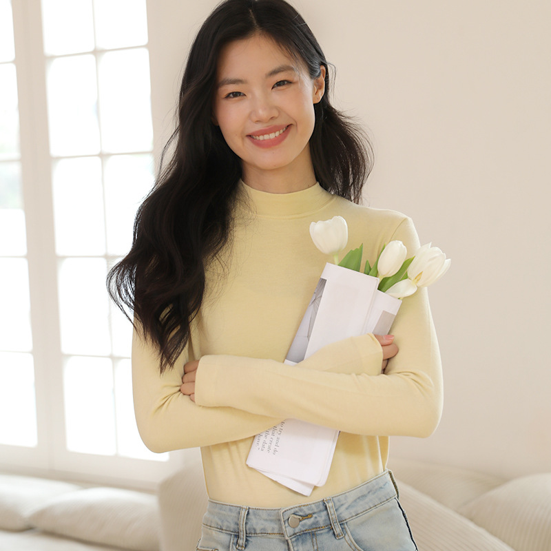 Long sleeved top with high collar on the outside and knitted sweater on the inside