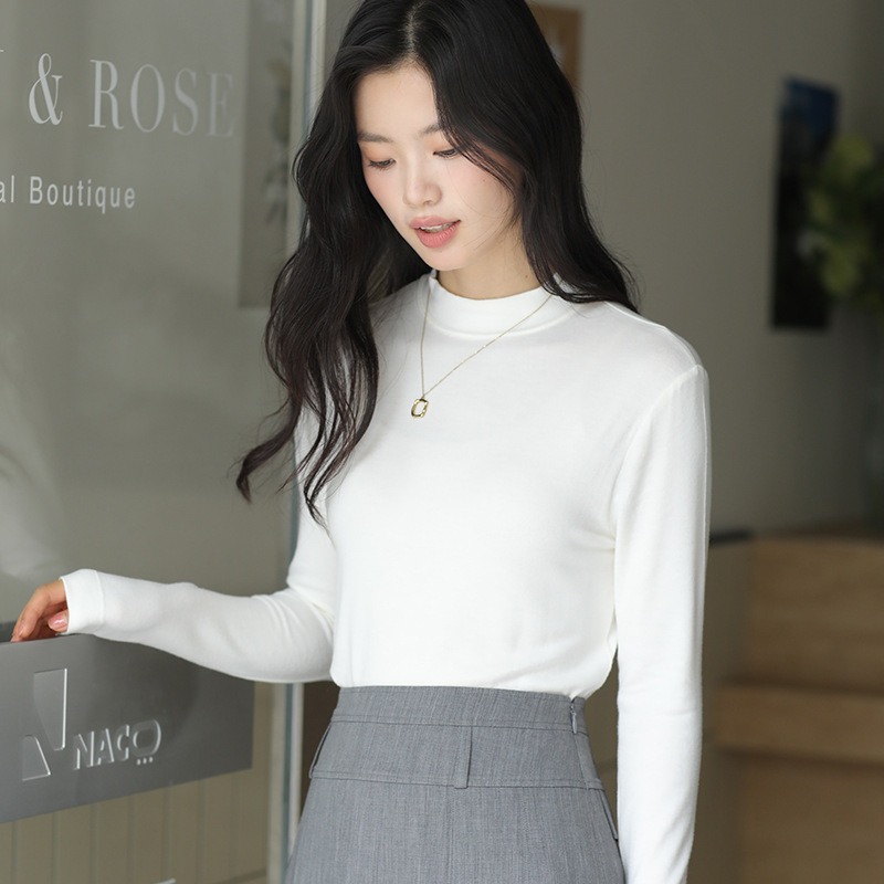 Long sleeved top with high collar on the outside and knitted sweater on the inside
