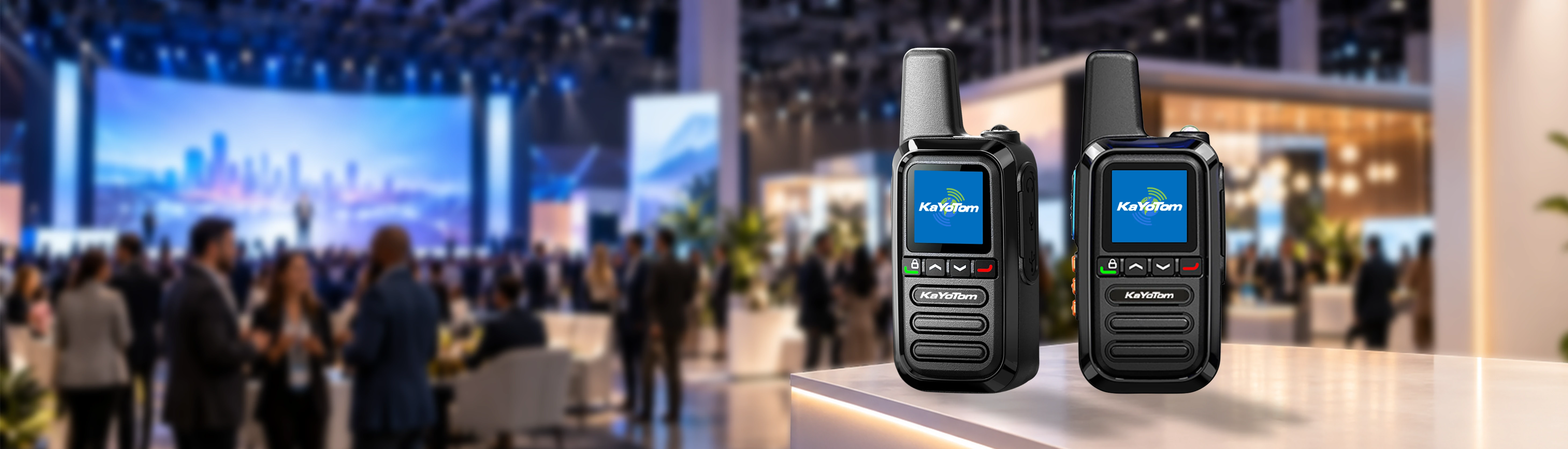 KayoTom G05 dual rugged two-way radios showcased on a modern exhibition counter with a business convention background